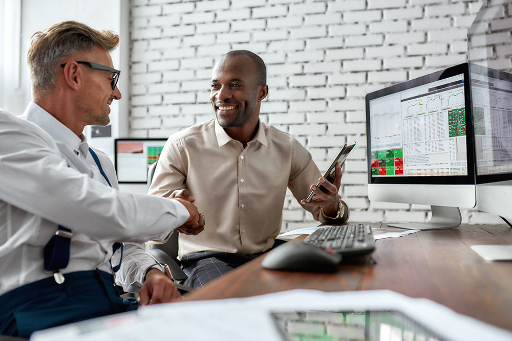 Two men working at a desk in an office